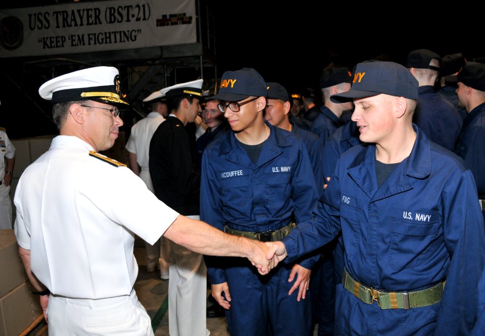 US Navy 110526-N-IK959-763 Rear Adm. David F. Steindl, commander of Naval Service Training Command (NSTC), congratulates a recruit following a capp