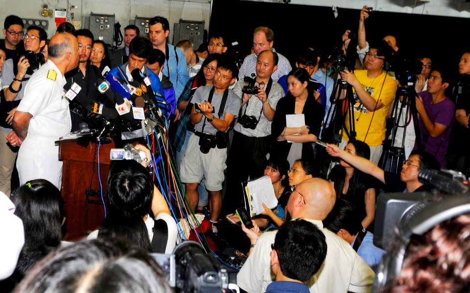 US Navy 110522-N-OK922-078 Rear Adm. Samuel Perez, commander of Carrier Strike Group 1, speaks to the media during a press conference in the hangar