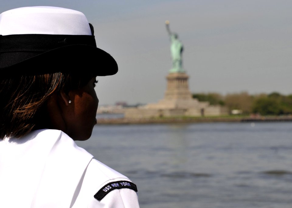 US Navy 110525-N-2147L-003 Logistics Specialist 1st Class Joquel Chappel watches from the flight deck of the amphibious transport dock ship USS New