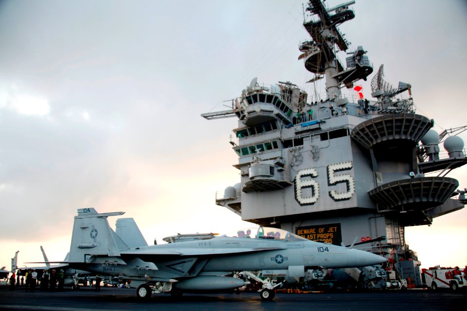 US Navy 110524-N-5082P-003 Pilots pause their F-A-18F Super Hornet in front of the island after making the 400,000th arrested landing aboard the ai