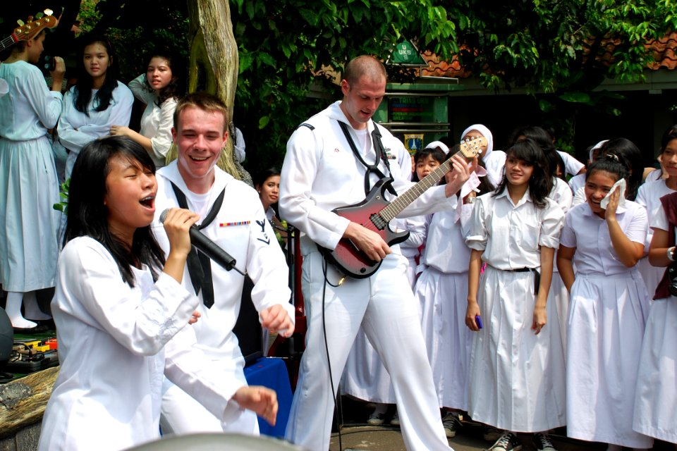 US Navy 110527-N-VP123-771 Musician 3rd Class Gabriel Brown invites a student of SMAN-21 High School in Jakarta to help perform a song