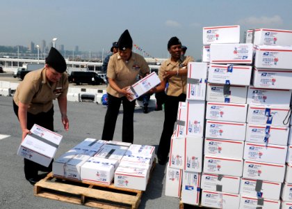 US Navy 110526-N-VE788-033 Sailors aboard the multipurpose amphibious assault ship USS Iwo Jima (LHD 7) stack care packages on the flight deck duri