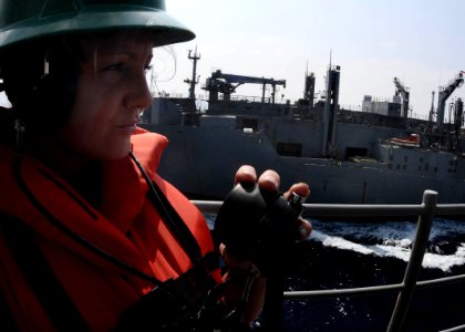 US Navy 110525-N-7508R-002 Boatswain's Mate Seaman Jennifer Patterson stands phone-talker watch aboard USS Bataan (LHD 5) during a replenishment at