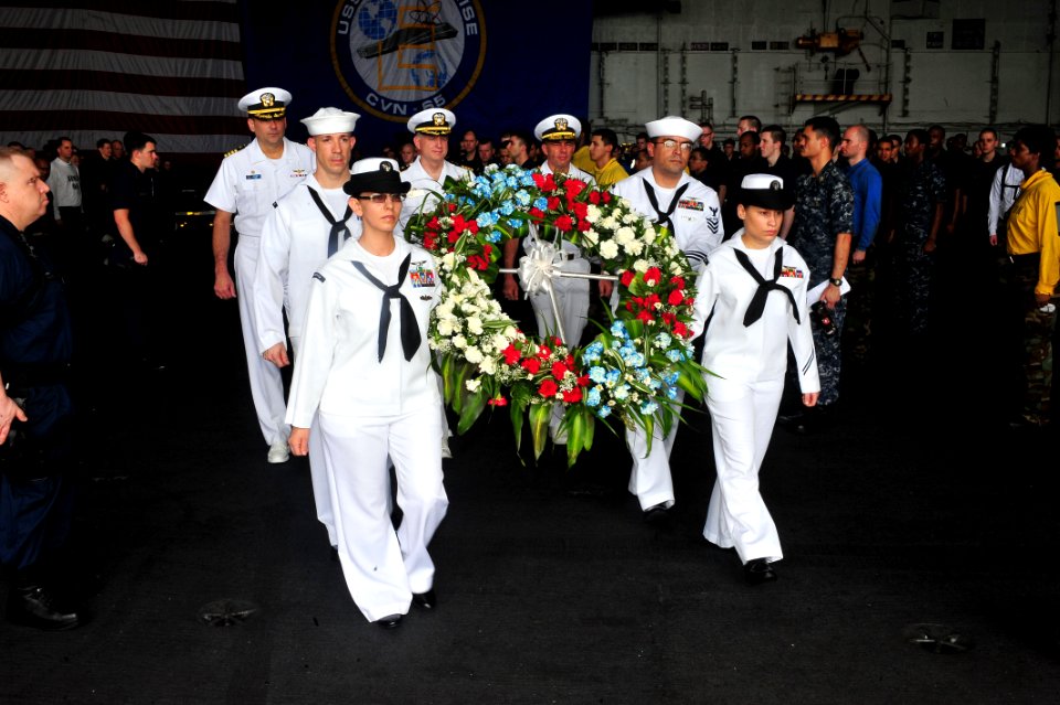 US Navy 110527-N-CH661-047 Sailors prepare to lay a wreath in the water during a Memorial Day commemoration aboard the aircraft carrier USS Enterpr