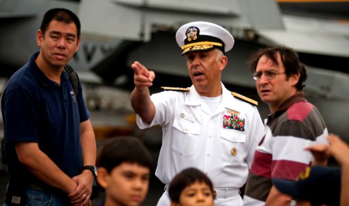 US Navy 110525-N-TU221-539 Rear Adm. Samuel Perez, commander of Carrier Strike Group (CSG) 1, gives visitors a tour of the flight deck of the Nimit photo