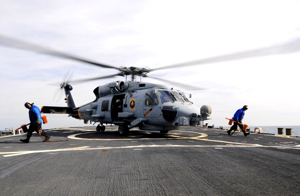 US Navy 110525-N-XQ375-065 oatswain's Mate Seaman Lucio Robles, left, and Seaman Matt Binnie clear the flight deck after removing the chocks and ch