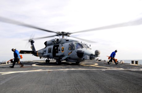 US Navy 110525-N-XQ375-065 oatswain's Mate Seaman Lucio Robles, left, and Seaman Matt Binnie clear the flight deck after removing the chocks and ch