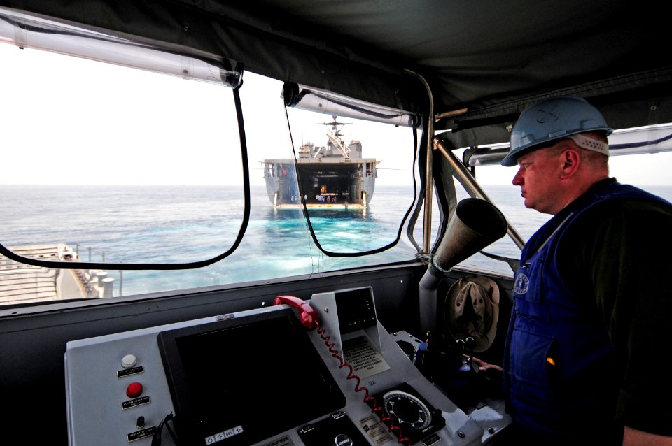 US Navy 110601-N-RC734-257 Boatswain's Mate 1st Class AJ Dean directs an LCU as it departs the well deck of USS Comstock (LSD 45)