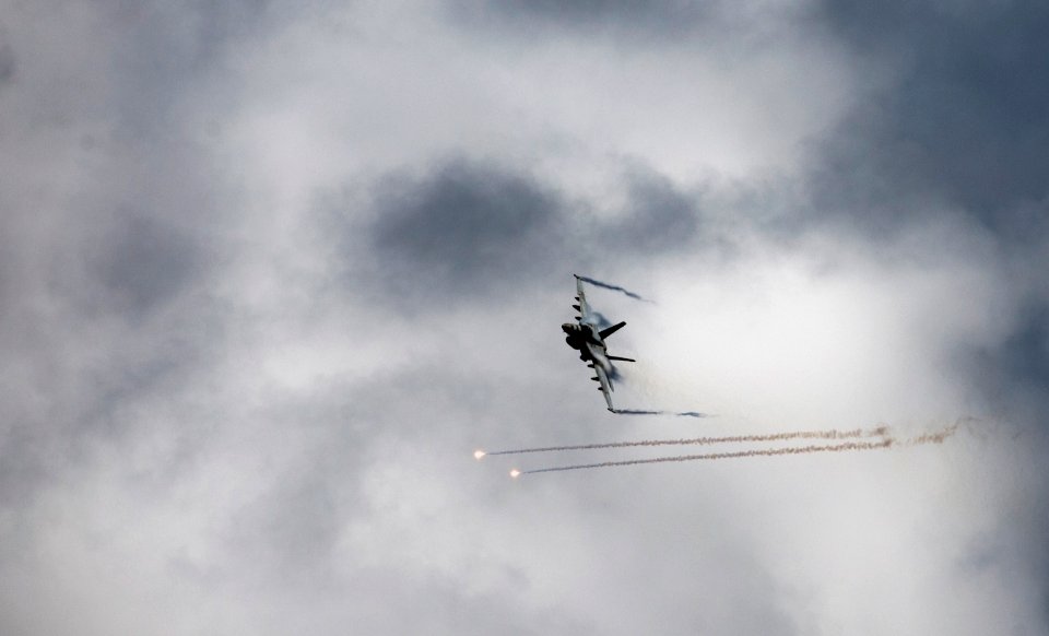 US Navy 110531-N-TU221-167 An F-A-18E Super Hornet assigned to Strike Fighter Squadron (VFA) 81 deploys flares during an air power demonstration ov