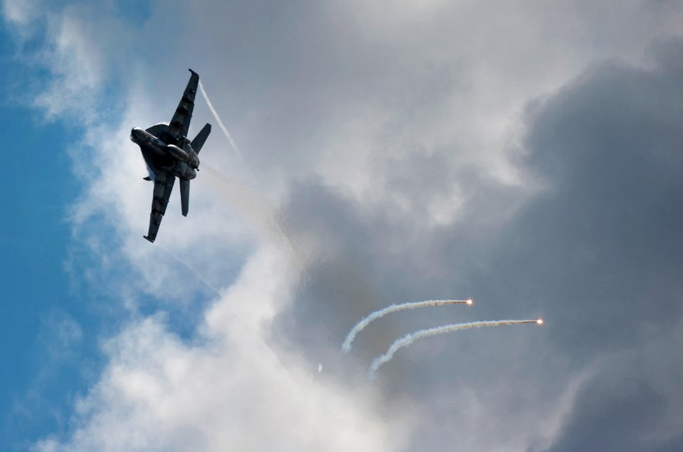 US Navy 110531-N-DR144-524 An F-A-18E Super Hornet deploys flares alongside USS Carl Vinson (CVN 70) during an air power demonstration