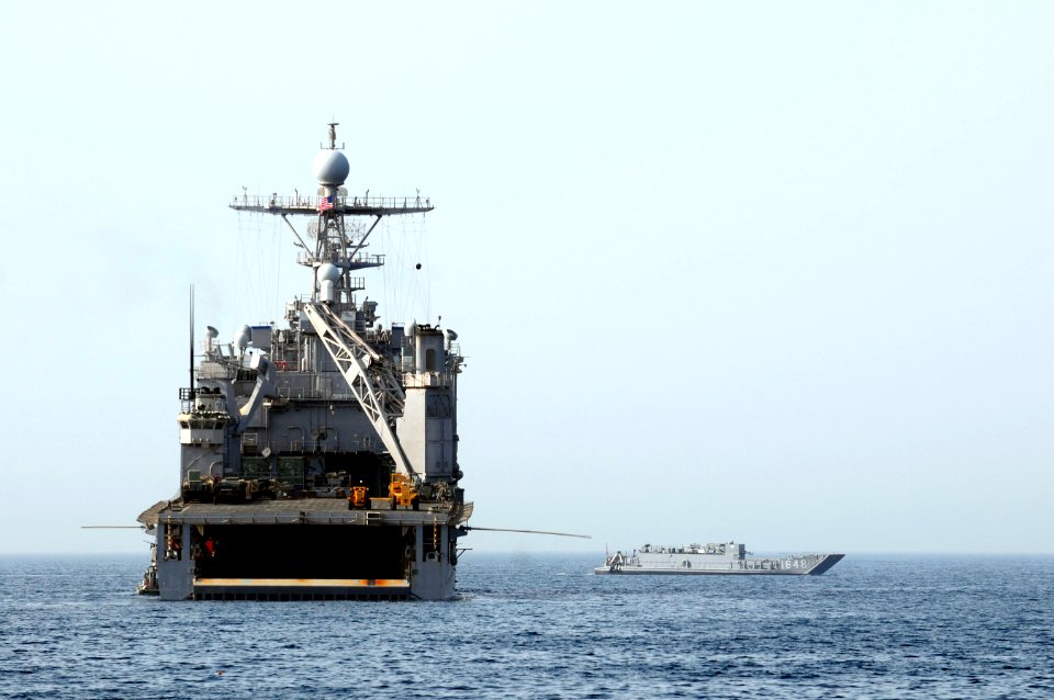 US Navy 110601-N-RC734-497 Landing Craft Utility (LCU) 1648 passes SS Comstock (LSD 45) at anchor