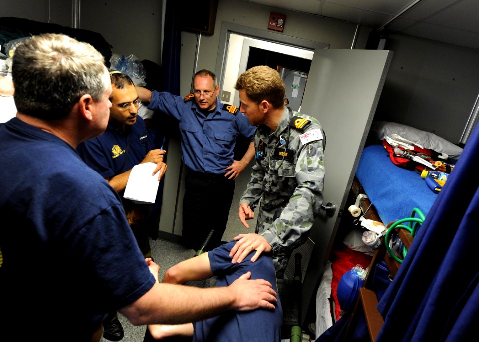US Navy 110531-N-BA263-039 Royal Australian Navy Lt. Cmdr. Joel Hissink, right, discusses a patient's status with Israeli navy Lt. Cmdr. Roneu Bar