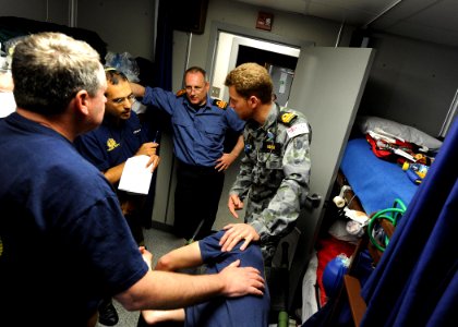 US Navy 110531-N-BA263-039 Royal Australian Navy Lt. Cmdr. Joel Hissink, right, discusses a patient's status with Israeli navy Lt. Cmdr. Roneu Bar