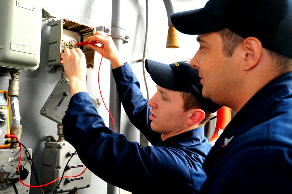 US Navy 110602-N-VL413-011 Interior Communications Electrician Fireman Michael Colonna, left, from Sterling Heights, Mich., and Interior Communicat