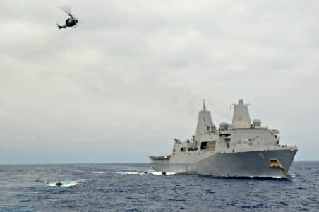US Navy 110528-N-XO436-020 Rigid-hull inflatable boats and a UH-1N Huey helicopter assigned to the San Antonio-class amphibious transport dock ship