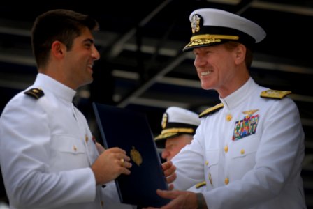 US Navy 110527-N-OA833-012 Vice Adm. Michael Miller, superintendent of the U.S. Naval Academy, congratulates a newly commissioned graduate photo