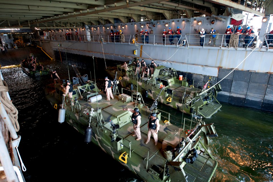 US Navy 110531-N-MR305-258 Sailors moor a Riverine patrol boat (RPB) and Riverine command boats in the well deck of USS Oak Hill (LSD 51) during a