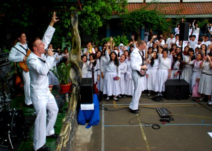 US Navy 110527-N-VP123-526 Musician 3rd Class Gabriel Brown sings a cover of the Tiao Cruz song Dynamite, during a concert at SMAN-21 High School i