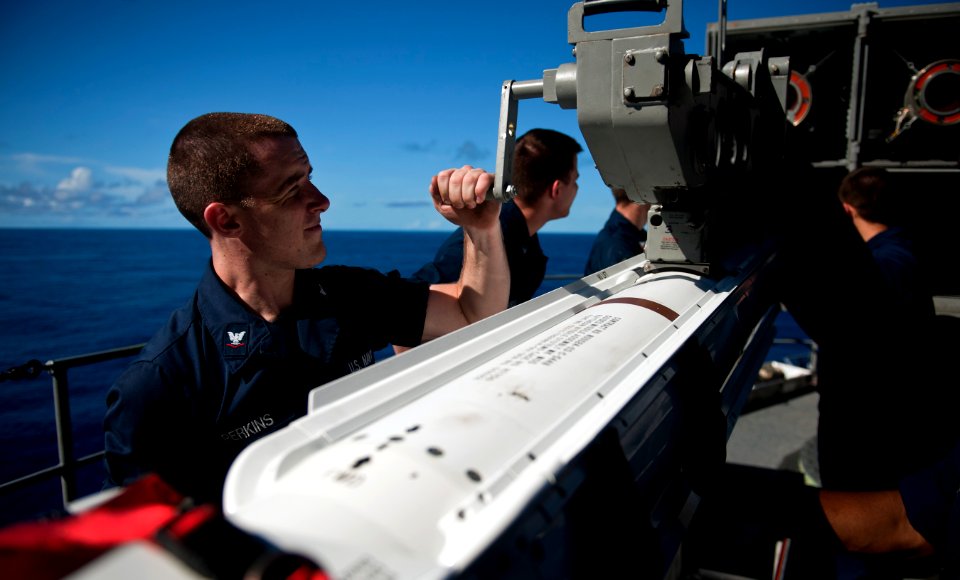 US Navy 110530-N-TU221-237 Fire Controlman 3rd Class Patrick Perkins, assigned to the combat systems department, uses a hand crank to position a RI