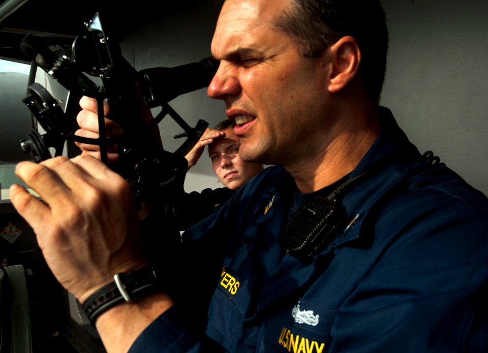 US Navy 110528-N-DR144-722 Master Chief Quartermaster Jonathan Myers teaches Midshipman 2nd Class Kathryn Schroedel how to use a sextant for celest
