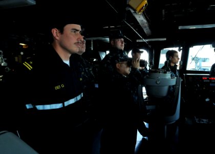US Navy 110603-N-NL541-177 Lt. Cmdr. Ronnie Magnsat, executive officer of the guided-missile frigate USS Thach (FFG 43), scans the horizon with bin