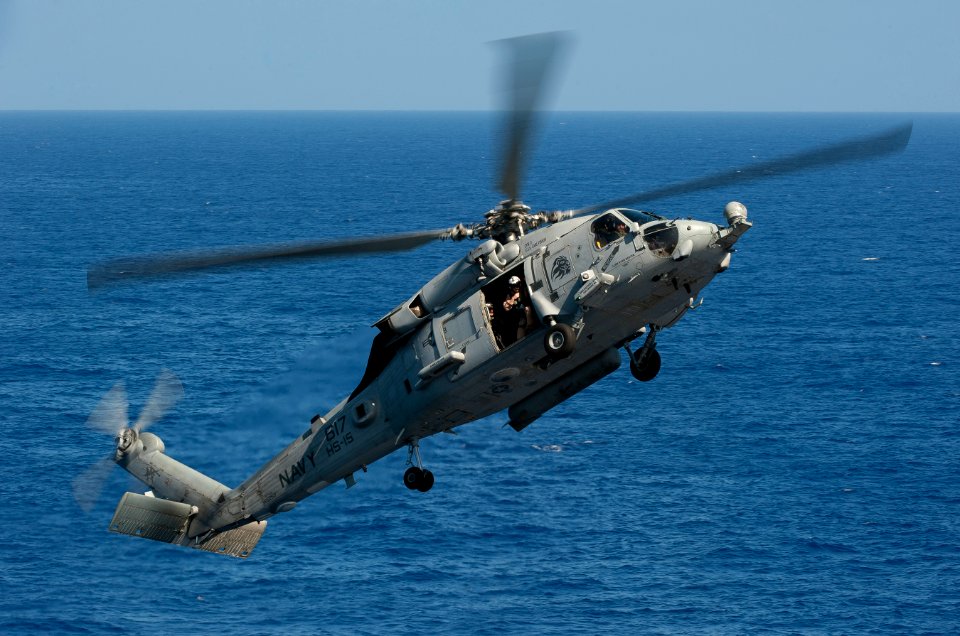 US Navy 110603-N-DR144-261 An HH-60H Sea Hawk helicopter approaches USS Carl Vinson (CVN 70) to simulate a fast rope deployment of special operatio
