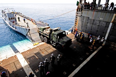US Navy 110601-N-RC734-172 A U.S. Marine Corps 7-ton truck enters the well deck aboard USS Comstock (LSD 45) during stern gate marriage operations