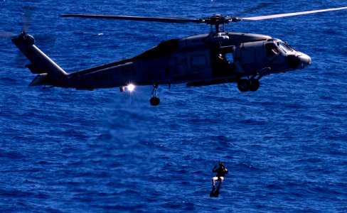 US Navy 110603-N-TU221-525 A search and rescue swimmer is deployed from an SH-60F Sea Hawk helicopter assigned to Helicopter Anti-submarine squadro