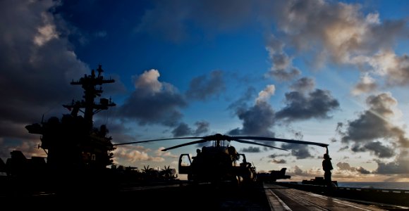 US Navy 110530-N-TU221-579 Sailors assigned to Helicopter Anti-submarine Squadron (HS) 15 spread the rotors of an HH-60F Sea Hawk helicopter aboard