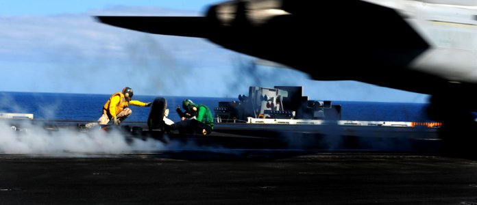 US Navy 110604-N-OY799-023 Lt. Shane Zimmerman signals as an F-A-18C Hornet from the Golden Dragons of Strike Fighter Squadron (VFA) 192 launches f