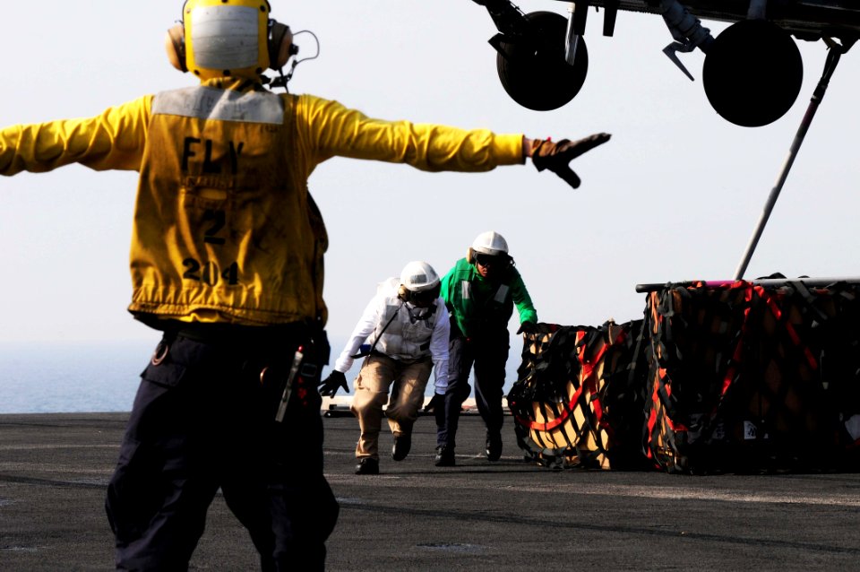 US Navy 110531-N-SB672-509 Aviation Boatswain's Mate (Handling) 3rd Class Fabian Cervantes, from Yuma, Ariz., signals to an MH-60S Sea Hawk helicop