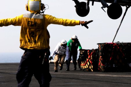 US Navy 110531-N-SB672-509 Aviation Boatswain's Mate (Handling) 3rd Class Fabian Cervantes, from Yuma, Ariz., signals to an MH-60S Sea Hawk helicop