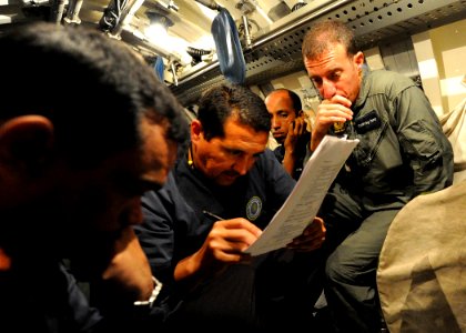 US Navy 110603-N-BA263-021 Navy Diver 1st Class Gene Perez reviews operational procedures as the U.S. Navy Submarine Rescue Diving and Recompressio