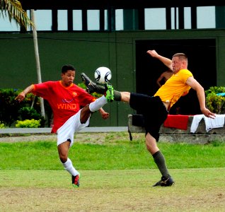 US Navy 110605-N-EP471-142 Hospital Corpsman 2nd Class Brett Myers, from Danville, Va., beats an opposing player to the ball in an exhibition socce