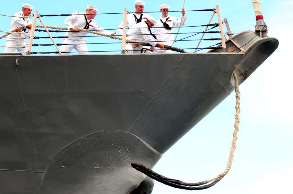 US Navy 110601-N-KT462-571 Sailors aboard the guided-missile destroyer USS Chung Hoon (DDG 93) heave mooring lines before getting underway from Joi