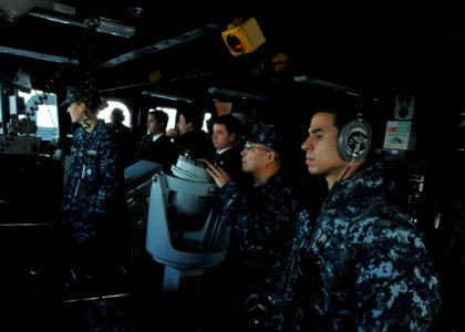 US Navy 110603-N-NL541-160 Lt. Cmdr. Ronnie Mangsat, executive officer of the guided-missile frigate USS Thach (FFG 43), operates the pelorus as he