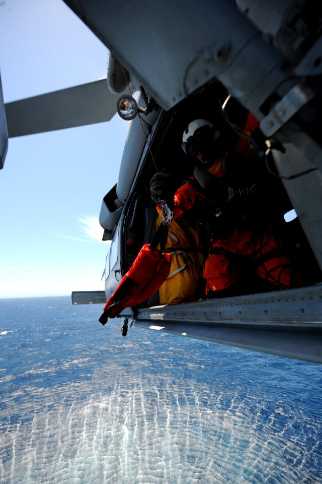 US Navy 110602-N-YZ751-324 Midshipman 1st Class Tyler Nichols lowers a rescue harness from an MH-60S Sea Hawk helicopter during search and rescue t