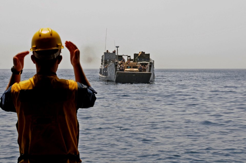 US Navy 110601-N-RC734-111 Boatswain's Mate Seaman Christopher Jenkins guides Landing Craft Utility (LCU) 1648 to the well deck during stern gate m