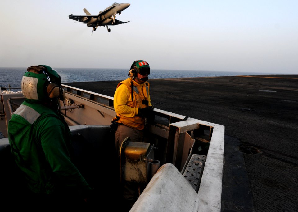 US Navy 110605-N-SB672-177 Aviation Boatswain's Mate (Equipment) 2nd Class Michael McClendon, left, and Lt. Brandon Decker man the arresting gear d