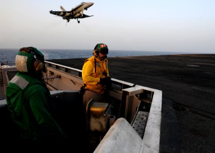 US Navy 110605-N-SB672-177 Aviation Boatswain's Mate (Equipment) 2nd Class Michael McClendon, left, and Lt. Brandon Decker man the arresting gear d