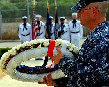 US Navy 110603-N-MO201-016 Master-at-Arms 1st Class Brandon Miller lays a wreath commemorating the 69th anniversary of the Battle of Midway during