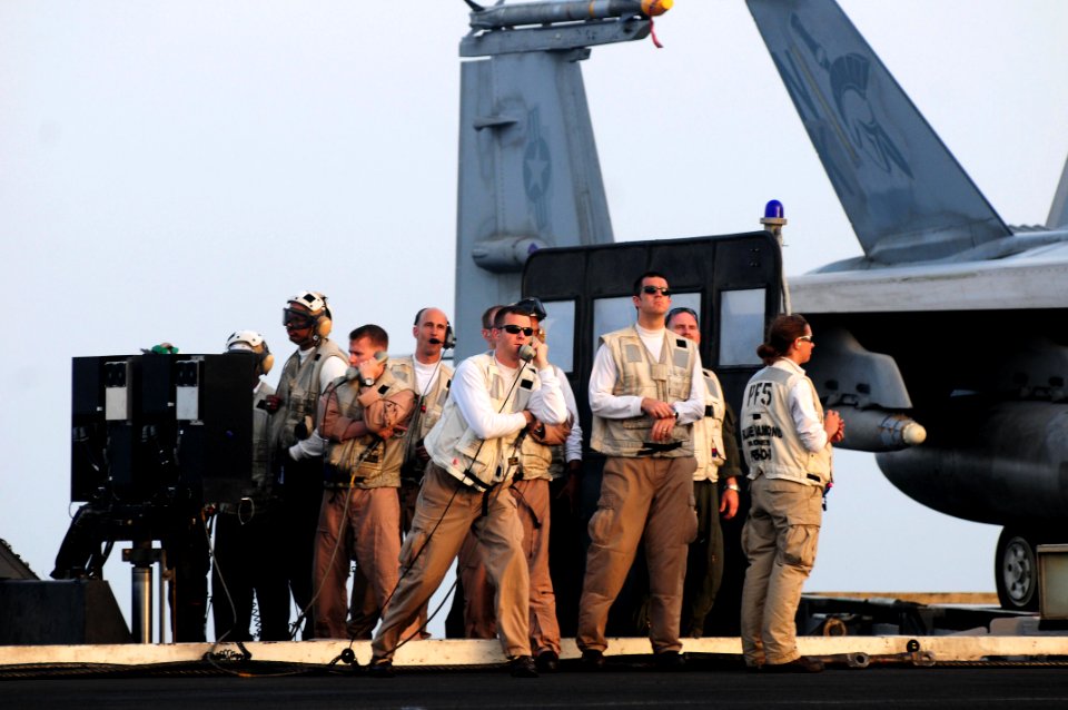 US Navy 110605-N-SB672-191 Landing signal officers watch from the LSO platform as an aircraft lands aboard USS Ronald Reagan (CVN 76)