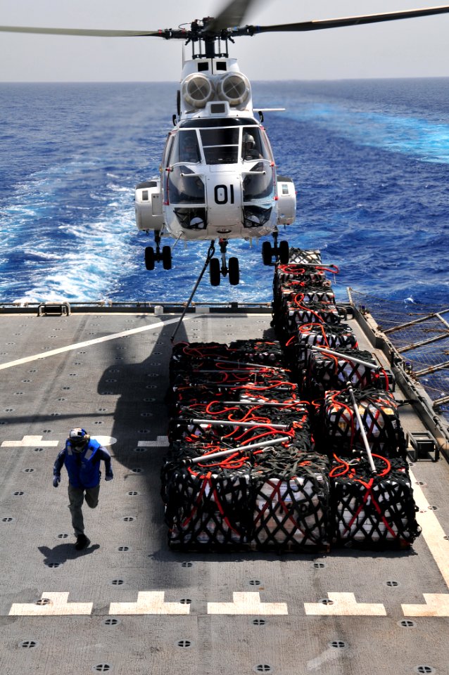 US Navy 110606-N-ZS026-041 Civilian mariner Delbert Desparrois gets clear of the landing area aboard the Military Sealift Command dry cargo and amm