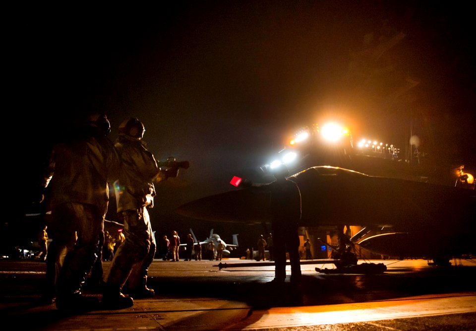 US Navy 110604-N-DR144-345 Flight deck personnel fight a simulated aircraft fire during crash and salvage drills on the flight deck of the Nimitz-c