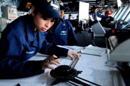 US Navy 110604-N-QL471-112 Quartermaster Seaman Angelica Rodriguez plots points on a map aboard the aircraft carrier USS George H.W. Bush (CVN 77) photo