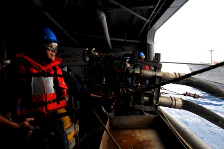 US Navy 110606-N-KA046-013 Boatswain's Mate Seaman Corey Esworthy heaves a line aboard USS Bataan (LHD 5) during a replenishment at sea