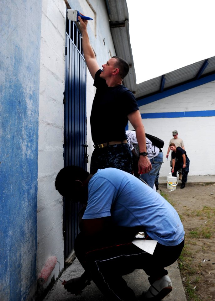US Navy 110604-N-QD416-122 Cmdr. Ray Houk, from Shelby, Ohio, and Colombian citizens paint the walls of the Institucion Ciudadela Educativa Tumaco