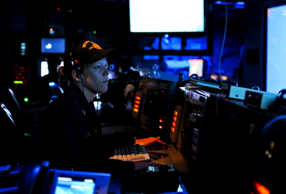 US Navy 110605-N-AQ172-055 Lt. Mary Lowell stands an instruction watch as the tactical action officer in the combat information center aboard the T