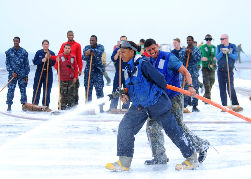 US Navy 110605-N-DS193-021 Sailors spray down the flight deck of the aircraft carrier USS George Washington (CVN 73) with aqueous film forming foam