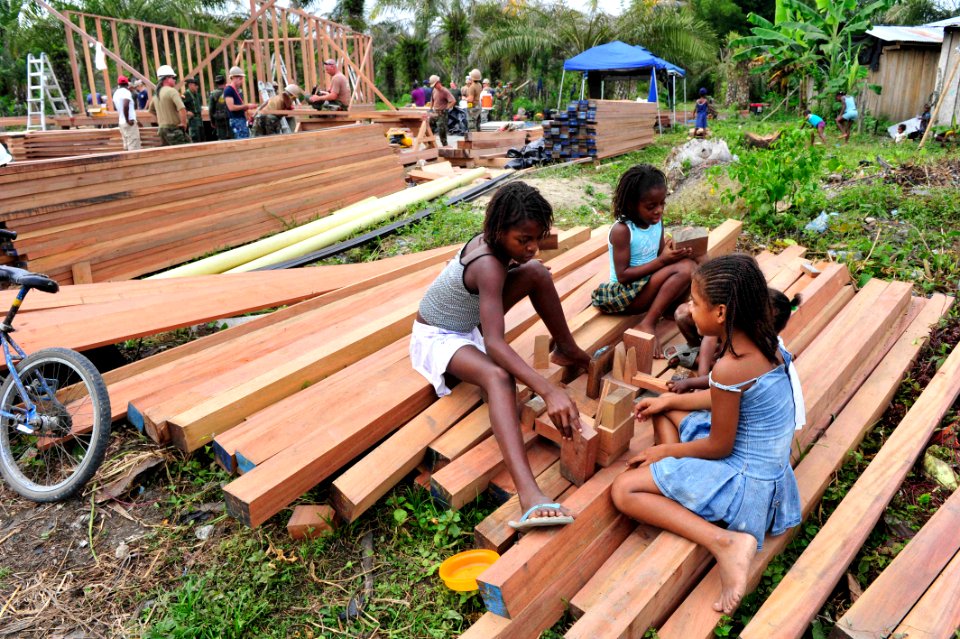 US Navy 110605-F-NJ219-179 Colombian children build a house out of scrap wood as Navy personnel build new classrooms at Escuela Cilvicito during a